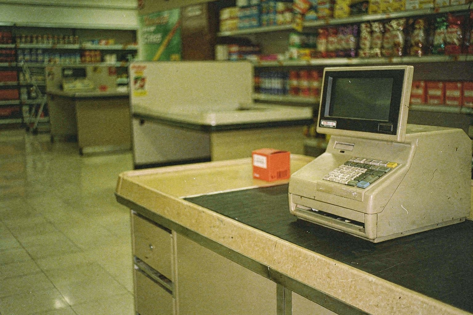 A red product at an empty supermarket checkout
