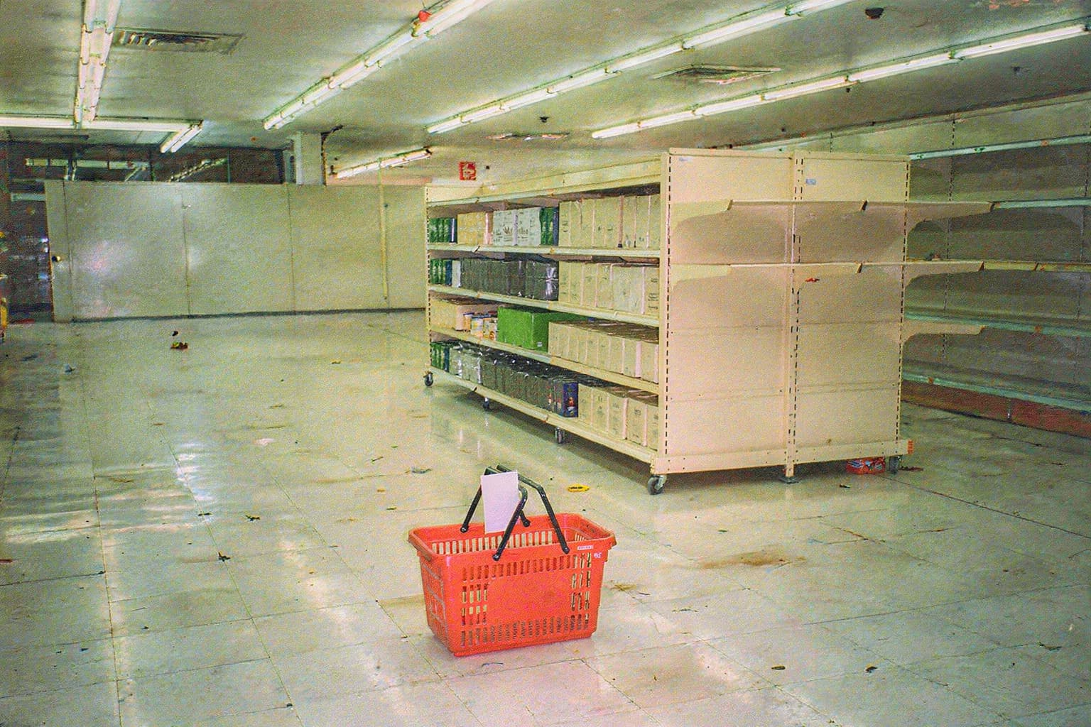 The movable aisle stocked with products around the red basket