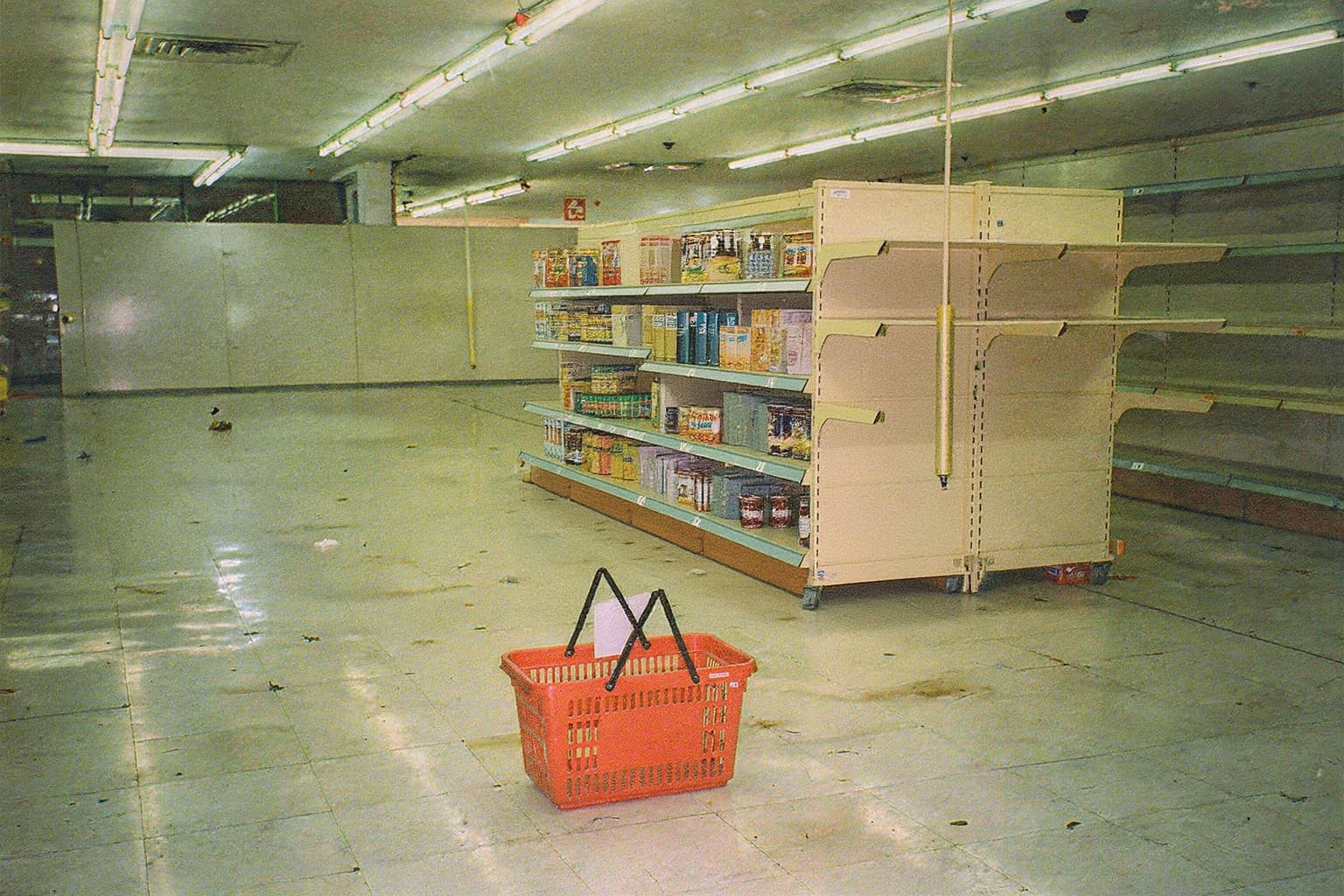 The movable aisle stocked with products around the red basket